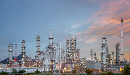 Refinery industry in Thailand An industrial area with the sky at sunset Oil and natural gas storage tanks, which are the petroleum refining industry.