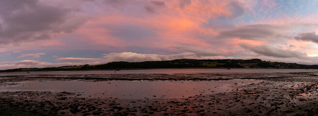 A panorama view of the Clyde River near Dumbarton at low tide at sunset