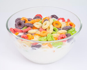 colored breakfast cereals laid out in a bowl on the white background top view, children's healthy breakfast