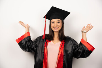 Fresh graduate in gown showing her hands on white background
