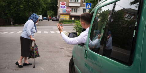 Angry car driver yelling at pedestrian