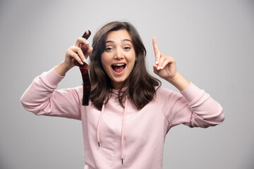 Happy young woman holding filmstrip