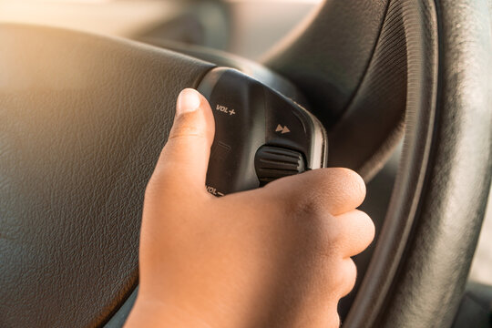 Boy Turning Up The Volume On His Father's Car Radio