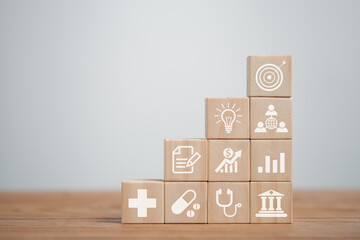 Wooden block with icons business, finance, medical care, business goals, success goals, business...