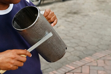 Merengue musician. Close-up of the hand and musical instrument guiro.