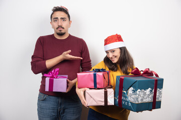 Young woman carrying a lot of Christmas presents