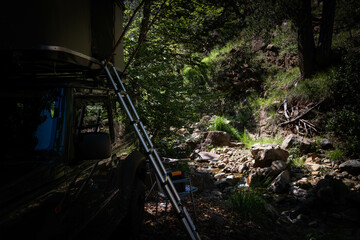 Camping in the forest and wilderness next to a stream. Top roof tent, off road car. Bush and Remote Camping.