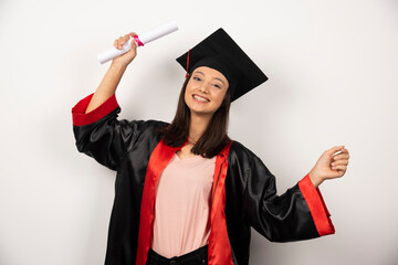 College graduate female in gown standing on white background