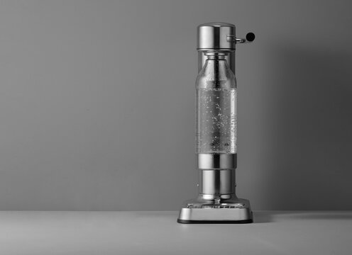 Soda Maker With Water Bottle On A Gray Background