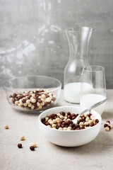 Breakfast cereal balls and milk.