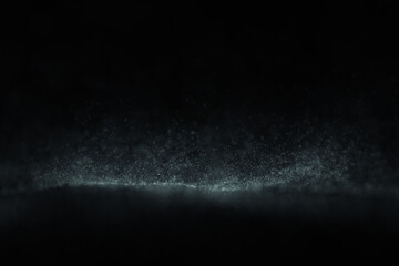 Abstract blurred dotted wave on clean black background.