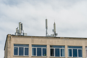 New GSM antennas on the roof of a building for transmitting a 5g signal are dangerous to health. Radiation pollution of the environment through cell towers. The threat of extinction of the population