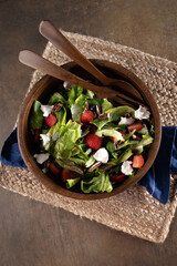 A green textured background with a healthy salad