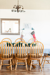 Oak dining room table with blue table cloth with Christmas decorations.