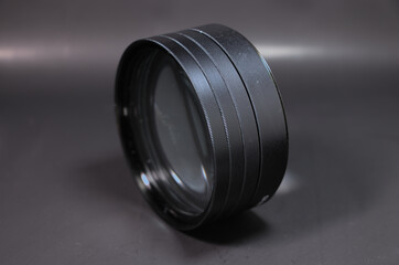 four Close up Lens Filter attached together and set on a black background