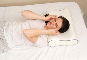 The woman woke up with a headache, a morning migraine or an improperly selected pillow.