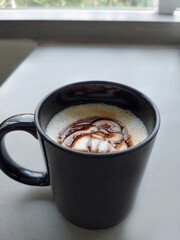 Black coffee cup on table.