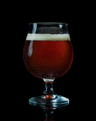 Detailed glass of beer on a black background