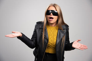 Blonde celebrity in black sunglasses looks upset and agressive