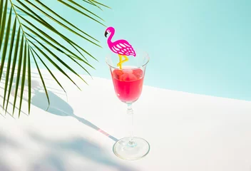 Fototapeten Creative summer composition with glass of juice, flamingo and palm leaf. Minimal summer drink concept. © Creative Photo Focus