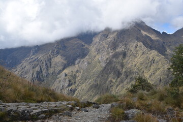 Hiking the green valleys and lush jungle and mountain landscape of the Inca Trail in Peru