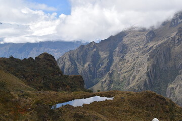 Fototapeta premium Hiking the green valleys and lush jungle and mountain landscape of the Inca Trail in Peru