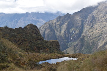 Hiking the green valleys and lush jungle and mountain landscape of the Inca Trail in Peru