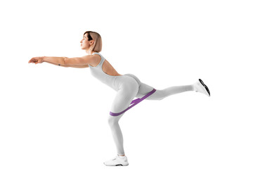 Sexy woman in sportswear using a resistance band in her exercise routine. Young woman performs fitness exercises on white background. Isolate