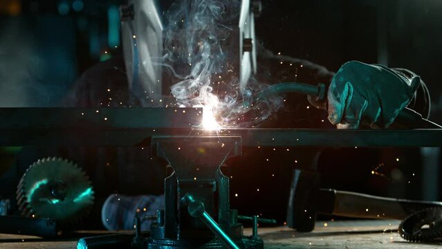 Super Slow Motion of Working Welder in Workshop. Detail shot, low depth of focus. Filmed on High Speed Cinema Camera, 1000 fps.