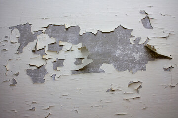 Peeling old plaster. Old dirty wall. Dilapidated concrete wall with cracked plaster.