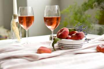 Dessert peaches and glass of wine on minimal white background
