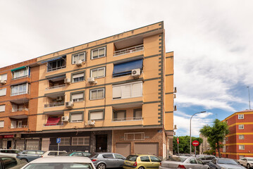 Facades of urban residential buildings with terraces on a cloudy and clear day