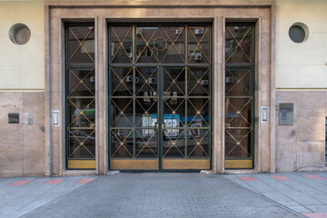 Facade of buildings with an entrance portal with a representative glass window