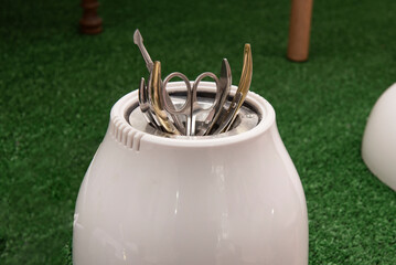Sterilization container for scissors, tweezers and nail clippers in a beauty salon