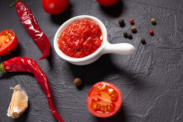 Chilly pepper and tomato sauce ingredient for homemade cooking at table