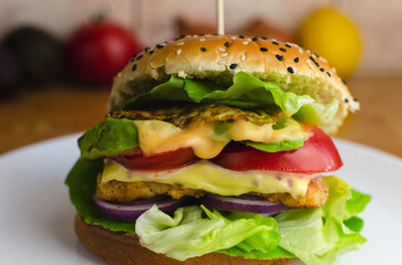 hamburger on a plate, food on a plate, hamburger with chicken, lettuce, tomato, avocado, onion