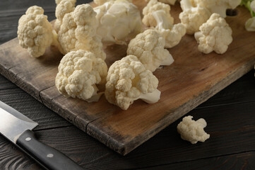 Raw, fresh organic cauliflower on a wooden background. Healthy eating, low carb diet concept