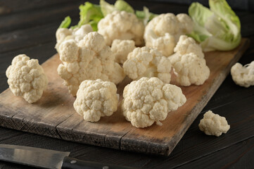 Raw, fresh organic cauliflower on a wooden background. Healthy eating, low carb diet concept