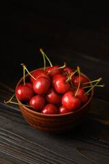 Sweet fresh cherry on a dark wooden background.