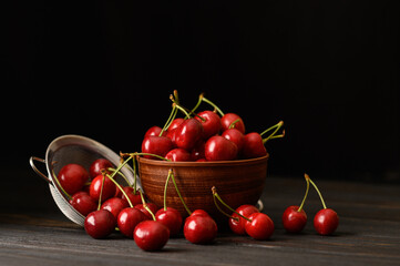 Sweet fresh cherry on a dark wooden background.
