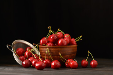 Sweet fresh cherry on a dark wooden background.