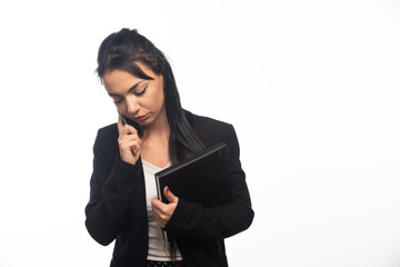 Business woman talking on cellphone on white background