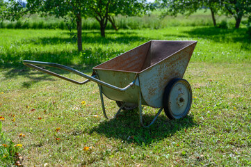 Garden cart, young apple trees in the background.