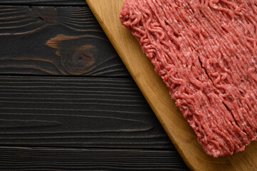 Raw mince beef, ground meat. Rustic background. Top view. Copy space