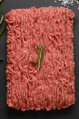 Raw mince beef, ground meat. Black background. Top view. Copy space