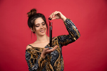 Brunette girl checks her photo history on polaroid film and looks satisfied