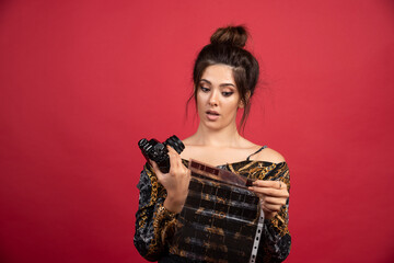 Brunette girl checks her photo history on polaroid film
