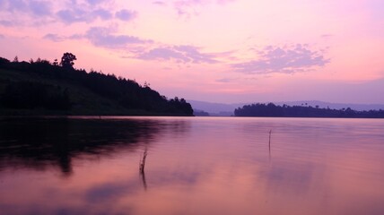 red sunset in the sky in uganda over the lake