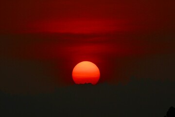 red sunset in the sky in uganda over the lake