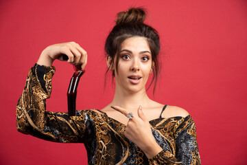 Brunette girl checks her photo history on polaroid film and looks satisfied